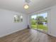 Bedroom features a serene view of the lake through a large sliding glass door and lots of natural light at 120 Hourglass Dr, Venice, FL 34293