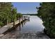 Boat ramp with a dock extending into a calm body of water at 120 Hourglass Dr, Venice, FL 34293