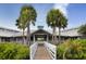A light gray community center with a boardwalk and palm trees at 120 Hourglass Dr, Venice, FL 34293