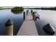 Private wooden dock providing direct water access and boat mooring, perfect for enjoying waterfront living at 120 Hourglass Dr, Venice, FL 34293