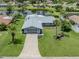 Charming single-story home with a well-manicured lawn and gray stone accents and attached two car garage at 120 Hourglass Dr, Venice, FL 34293