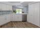 Bright kitchen with stainless appliances, white cabinets, and view of the outdoor pool area at 120 Hourglass Dr, Venice, FL 34293