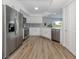 Modern kitchen with stainless steel appliances, white cabinets, and stylish backsplash at 120 Hourglass Dr, Venice, FL 34293