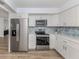 Well-appointed kitchen featuring stainless steel appliances, modern cabinetry, and a sleek design at 120 Hourglass Dr, Venice, FL 34293