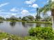 Picturesque lake view with lush greenery and clear reflections, offering a serene and natural backdrop at 120 Hourglass Dr, Venice, FL 34293