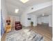 Open living room boasts vaulted ceilings, a ceiling fan, and wood floors at 120 Hourglass Dr, Venice, FL 34293