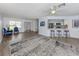 Bright living room with modern floors, stylish furniture, and a seamless view into the updated kitchen at 120 Hourglass Dr, Venice, FL 34293
