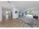 Spacious living room with wood flooring and abundant natural light, offering serene water views at 120 Hourglass Dr, Venice, FL 34293