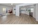 Open-concept living space with modern flooring and seamless flow into the stylish kitchen area at 120 Hourglass Dr, Venice, FL 34293