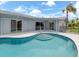Inviting in-ground pool with sun shelf and outdoor space, perfect for enjoying the Florida lifestyle at 120 Hourglass Dr, Venice, FL 34293