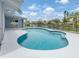 Refreshing in-ground pool with views of the lake, ideal for enjoying a relaxing day in the Florida sunshine at 120 Hourglass Dr, Venice, FL 34293