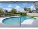 Inviting in-ground pool with a screened enclosure, perfect for outdoor relaxation and waterfront views at 120 Hourglass Dr, Venice, FL 34293