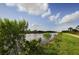 Picturesque view of a canal and paved walking path with abundant foliage at 120 Hourglass Dr, Venice, FL 34293