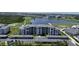 Beautiful aerial view of the condo community with a pond, golf course, and covered parking at 12140 Wellen Golf St # 202, Venice, FL 34293