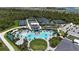 Aerial view of community pool and tennis courts with palm trees, umbrellas, and various neighborhood amenities at 12140 Wellen Golf St # 202, Venice, FL 34293