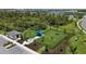 Aerial shot of dog park including shaded seating, lush landscaping, and various amenities for furry friends at 12140 Wellen Golf St # 202, Venice, FL 34293
