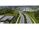Aerial view showcases the community's lush landscaping, neighborhood streets, lake, and attractive homes at 12140 Wellen Golf St # 202, Venice, FL 34293