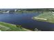 Scenic aerial view of a lake and golf course showcasing the lush greenery and surrounding buildings at 12140 Wellen Golf St # 202, Venice, FL 34293