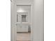 Bathroom featuring tiled floors, white cabinets and a mirror at 12140 Wellen Golf St # 202, Venice, FL 34293