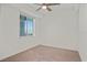 Image of carpeted bedroom with ceiling fan and large window allowing natural light at 12140 Wellen Golf St # 202, Venice, FL 34293