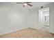Image of carpeted bedroom, ceiling fan, closet, and bathroom entrance at 12140 Wellen Golf St # 202, Venice, FL 34293