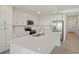 Bright kitchen features an island, stainless steel appliances, and modern white cabinets at 12140 Wellen Golf St # 202, Venice, FL 34293