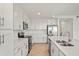 Modern kitchen with stainless steel appliances, white cabinets, and a spacious countertop at 12140 Wellen Golf St # 202, Venice, FL 34293