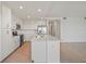 Modern kitchen featuring white cabinets, stainless steel appliances, and a spacious island at 12140 Wellen Golf St # 202, Venice, FL 34293