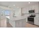 Well-lit kitchen with stainless steel appliances, large island, and a view of the water at 12140 Wellen Golf St # 202, Venice, FL 34293