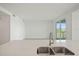 Bright living room with stainless steel sink and balcony at 12140 Wellen Golf St # 202, Venice, FL 34293
