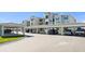 Image of covered parking area with several cars parked underneath at condo complex at 12140 Wellen Golf St # 202, Venice, FL 34293