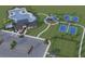 Aerial view of community amenities including a pool, tennis court, playground, and parking at 12617 Oak Hill Way, Parrish, FL 34219