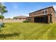 Expansive backyard with lush lawn, screened in porch, and privacy fence, perfect for outdoor living at 12617 Oak Hill Way, Parrish, FL 34219