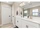Bathroom with a dual sink vanity, large mirror, and modern fixtures at 12617 Oak Hill Way, Parrish, FL 34219