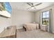 Bedroom with neutral walls, a wooden dresser, and a window offering outdoor views at 12617 Oak Hill Way, Parrish, FL 34219