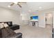 Cozy bonus room with a large TV and doorway leading to the upstairs bathroom at 12617 Oak Hill Way, Parrish, FL 34219