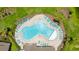 Aerial view of a community pool with lounge chairs surrounded by lush landscaping at 12617 Oak Hill Way, Parrish, FL 34219