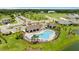 An aerial view of the community pool, clubhouse, parking, and surrounding green spaces at 12617 Oak Hill Way, Parrish, FL 34219