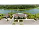 Aerial view of community pool, clubhouse, parking, and lake with fountain at 12617 Oak Hill Way, Parrish, FL 34219