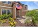 Charming two-story home features an inviting entrance, landscaping, and an American flag at 12617 Oak Hill Way, Parrish, FL 34219