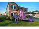 Charming home featuring beautiful landscaping, a paved walkway, and vibrant LED lighting for curb appeal at 12617 Oak Hill Way, Parrish, FL 34219