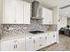 Modern kitchen with white cabinets, stainless steel appliances, decorative backsplash, and ample counter space at 12617 Oak Hill Way, Parrish, FL 34219