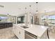 Open floor plan with kitchen island, dining area, and living room, perfect for entertaining at 12617 Oak Hill Way, Parrish, FL 34219