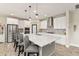 Modern kitchen featuring white cabinets, a large island with seating, and stainless steel appliances at 12617 Oak Hill Way, Parrish, FL 34219