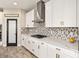 Gourmet kitchen featuring white cabinets, granite countertops, gas range, and stainless steel hood at 12617 Oak Hill Way, Parrish, FL 34219
