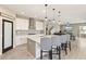 Bright and open kitchen features white cabinets, a large island, and bar seating at 12617 Oak Hill Way, Parrish, FL 34219