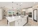 Open kitchen with a large island, pendant lighting, stainless steel appliances, and dining area at 12617 Oak Hill Way, Parrish, FL 34219