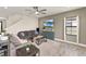 Comfortable living room with wood-look tile flooring, large TV, and access to the staircase at 12617 Oak Hill Way, Parrish, FL 34219