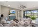 Spacious living room with comfortable seating, large TV, and sliding doors to the outdoor patio at 12617 Oak Hill Way, Parrish, FL 34219
