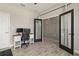 Home office with wood-look tile flooring, a desk with dual monitors, and glass paneled French doors at 12617 Oak Hill Way, Parrish, FL 34219